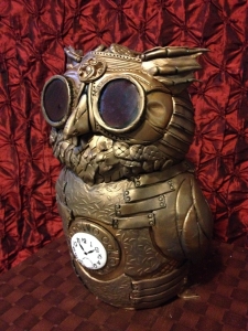 Steampunk Owl cake with dark, patterned background.  A bit busy and not a crisp view of cake details